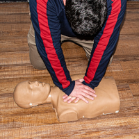 Someone doing CPR on a mannequin Someone doing CPR on a mannequin