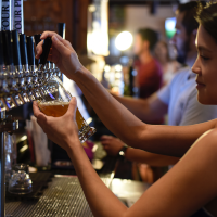 Person in bar pouring a drink Person in bar pouring a drink