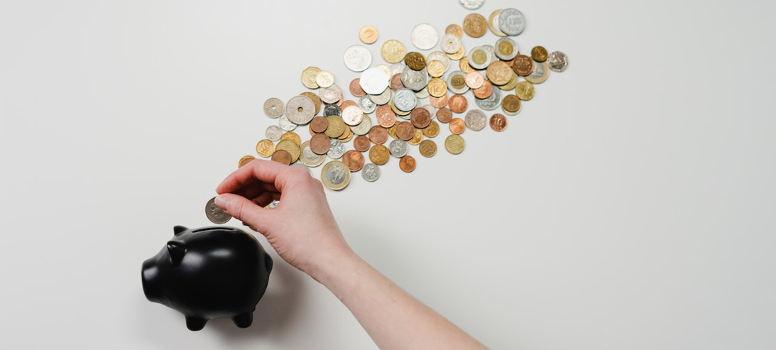 Piggy bank with coins coming out of it Piggy bank with coins coming out of it