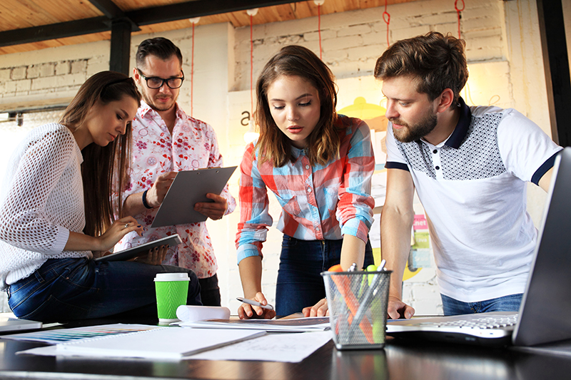 Group of four people having a casual business discussion Group of four people having a casual business discussion