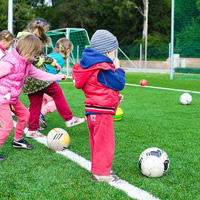 Young children playing football Young children playing football