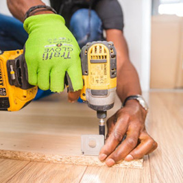 Someone drilling a screw into wood Someone drilling a screw into wood