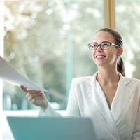 Female manager handing someone a document Female manager handing someone a document