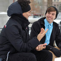 2 young men sitting and chatting to each other 2 young men sitting and chatting to each other