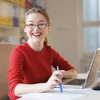 Happy woman at her desk Happy woman at her desk