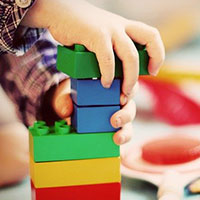 Toddler playing with colourful blocks Toddler playing with colourful blocks